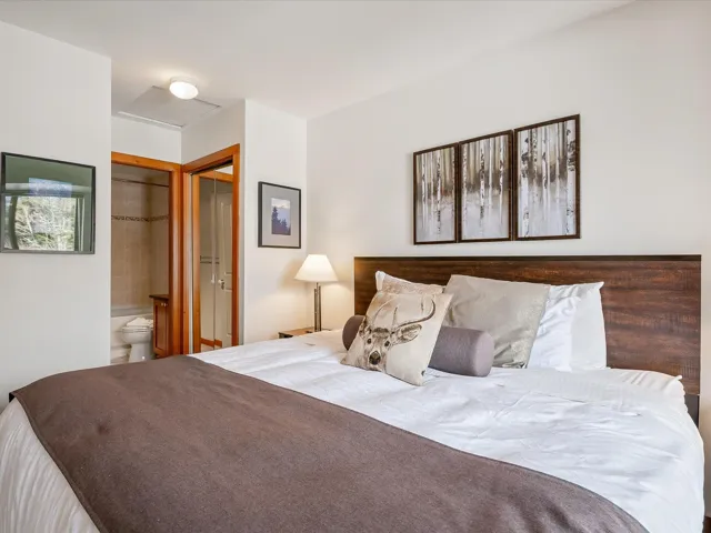 Bedroom with attic access and connected bathroom