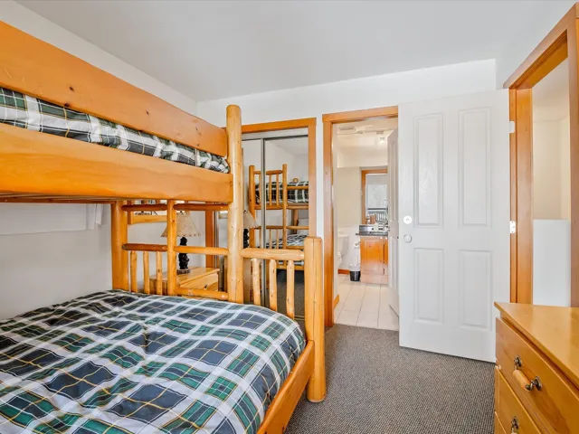 Bedroom featuring dark colored carpet