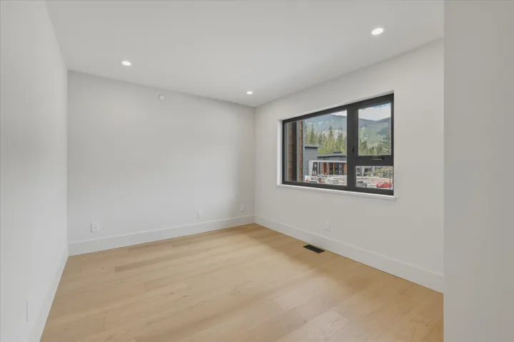 Open-concept living space with light wood-finish flooring