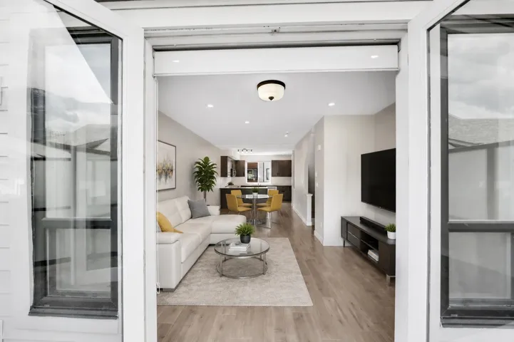Virtually staged living room and dining room.  Looking in from the balcony.