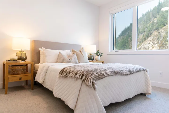 Bedroom featuring light carpet and baseboards