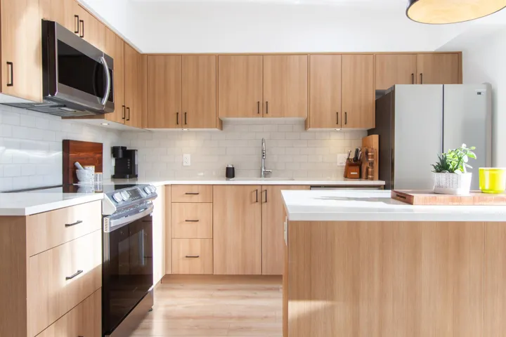 Kitchen featuring light brown cabinets, appliances with stainless steel finishes, and light countertops