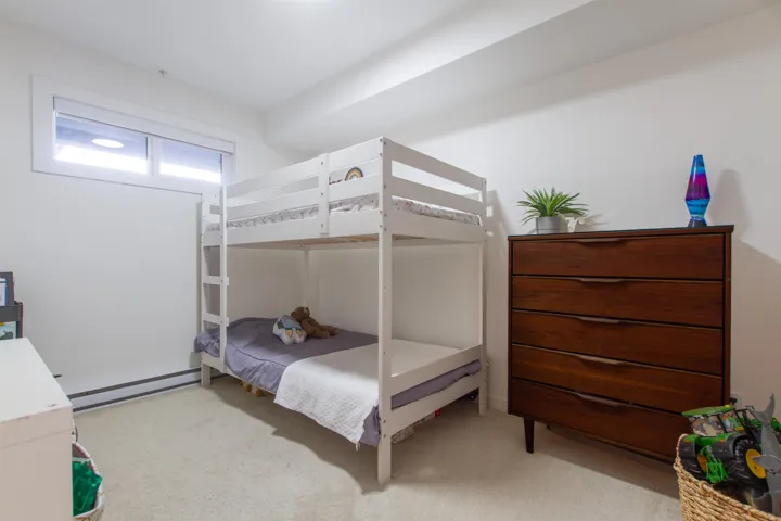 Bedroom with a baseboard radiator and carpet floors