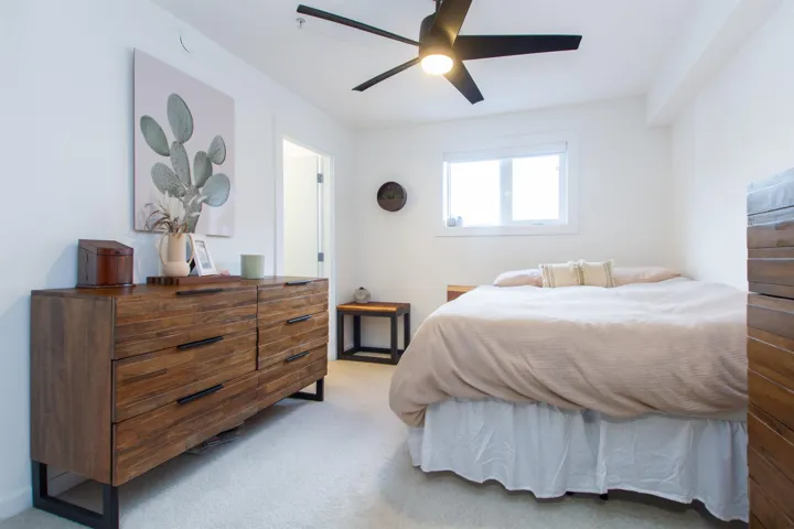 Bedroom featuring light carpet and ceiling fan
