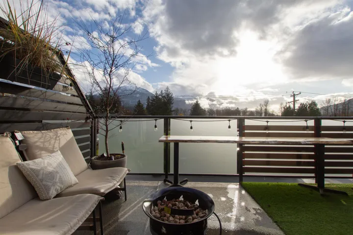 View of patio featuring a balcony and an outdoor fire pit
