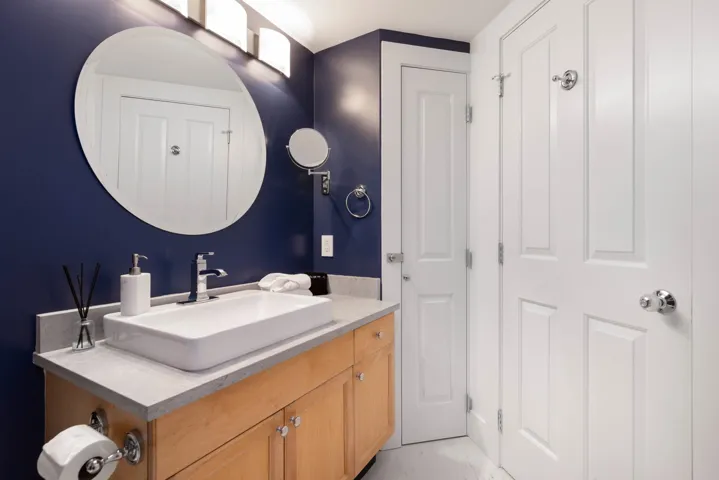 Bathroom with vanity and marble finish floor