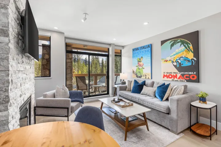 Living room with a fireplace, recessed lighting, and wood finished floors