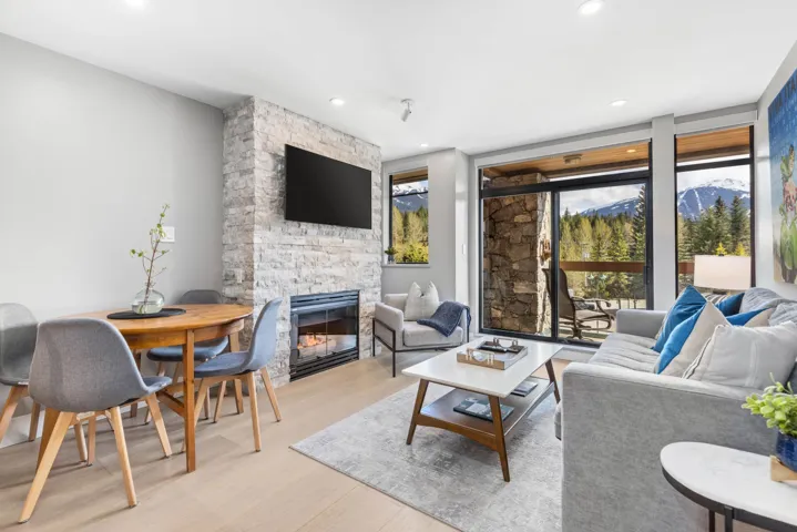 Living room featuring a fireplace, recessed lighting, and light wood-style flooring