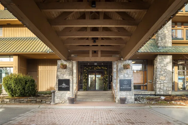 Property entrance featuring metal roof and stone siding
