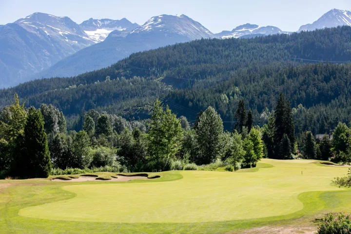 View of mountain feature featuring a wooded view and golf course view