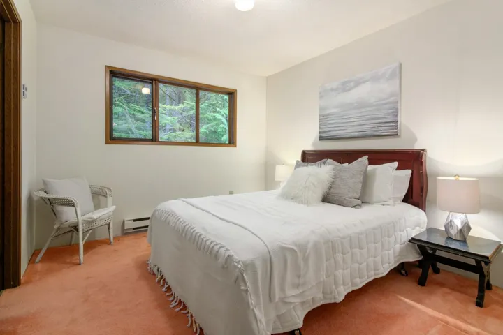 Bedroom featuring carpet floors and a baseboard radiator