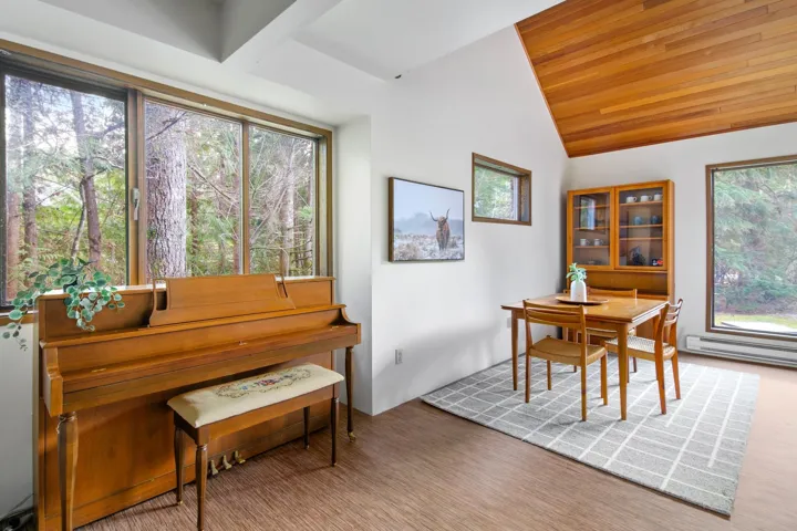 Interior space featuring wood ceiling, vaulted ceiling, and baseboard heating