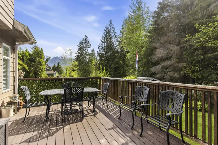 Expansive outdoor deck with wood-finish flooring and a natural wood railing