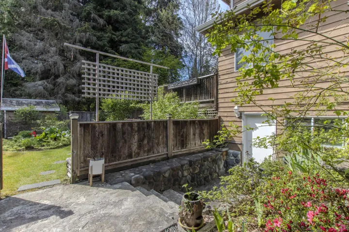 Rear exterior featuring horizontal wood siding and white trim windows