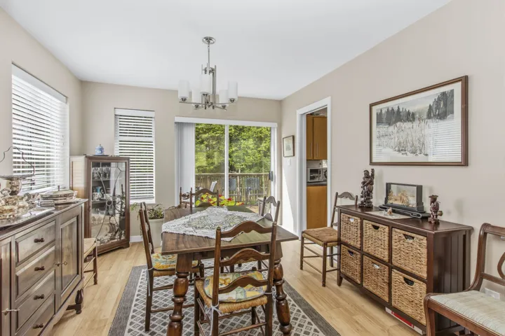 Dining area with wood-finish flooring and neutral wall tones