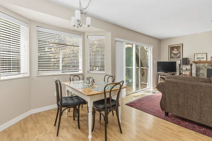 Dining area featuring light wood-finish flooring and a contemporary chandelier