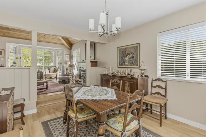 Formal dining area featuring neutral wall tones and wood-finish flooring