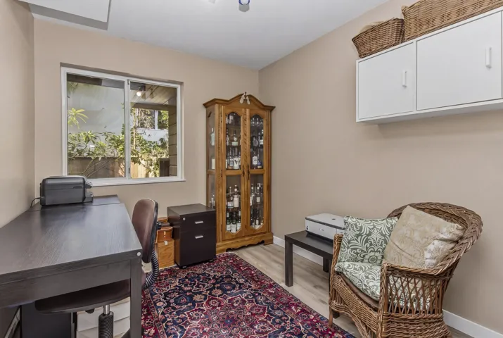 Bright room with a large window, light wood-finish flooring, and neutral wall tones