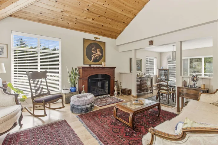 Vaulted wood-finish ceiling over a spacious room with light wood-finish flooring