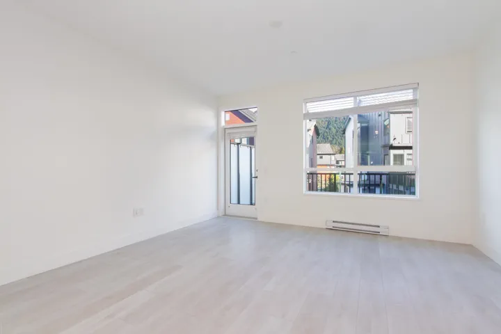 Unfurnished room with a baseboard radiator and light wood-style flooring