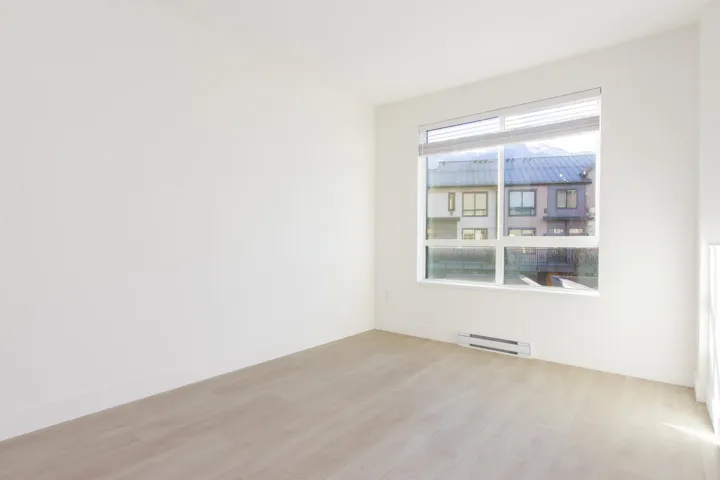 Spare room featuring light wood-style floors and a baseboard heating unit