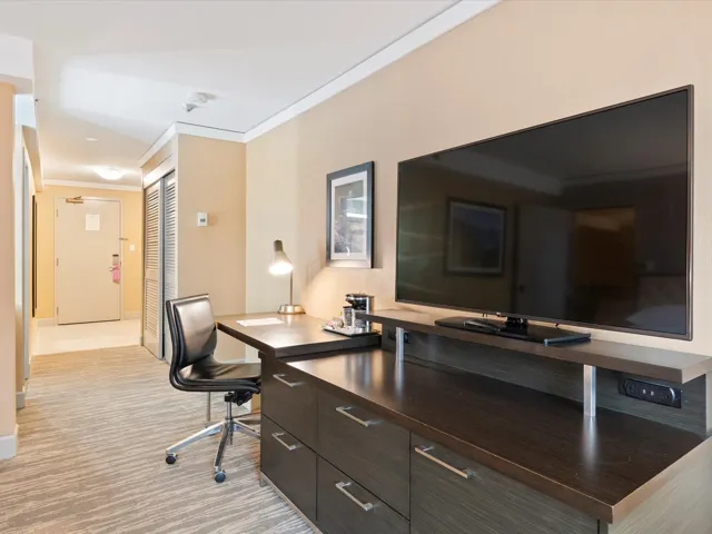 Carpeted office with baseboards and crown molding