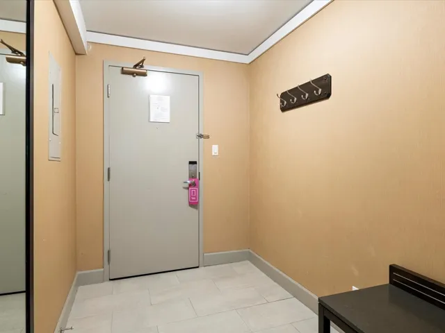 Doorway featuring baseboards and light tile patterned flooring