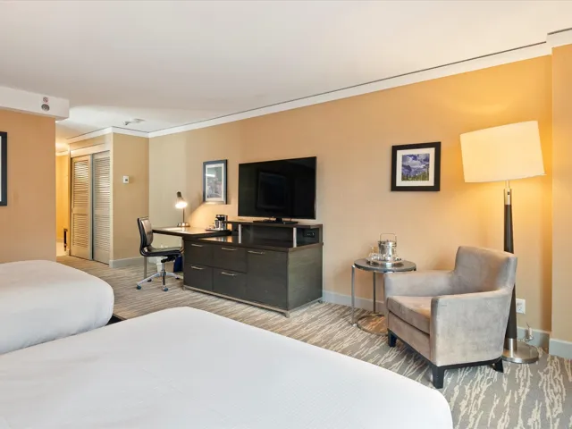 Bedroom featuring light carpet, baseboards, a closet, and crown molding
