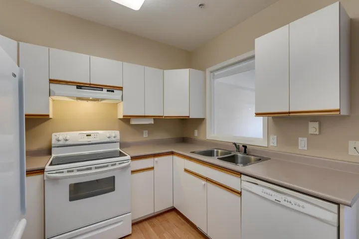 Kitchen featuring white cabinets and white appliances.