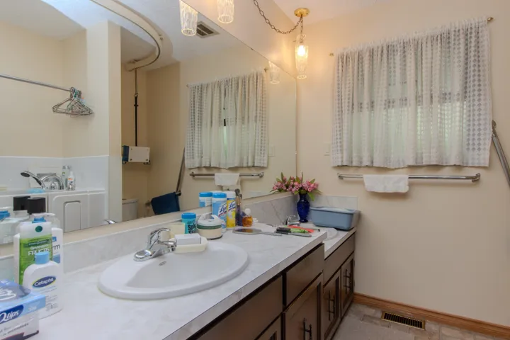 Bathroom with vanity and baseboards