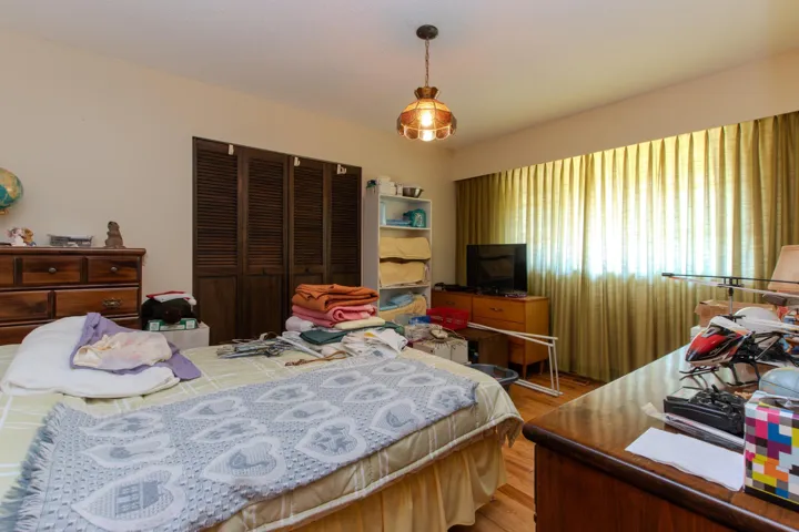 Bedroom with light wood-type flooring and a closet