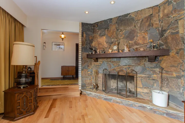 Living area featuring wood finished floors, a fireplace, and recessed lighting