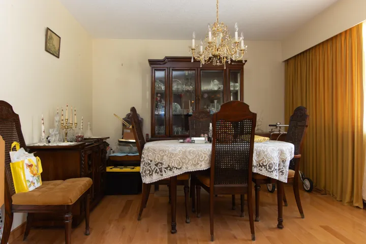 Dining room featuring light wood-type flooring, a chandelier, and a textured ceiling