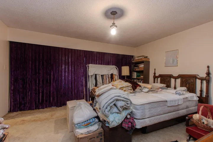 Bedroom featuring a textured ceiling and carpet