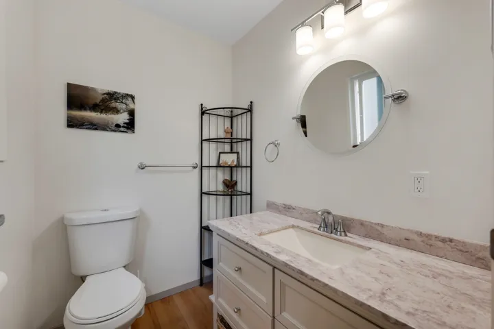 Half bathroom featuring vanity and light wood-style flooring