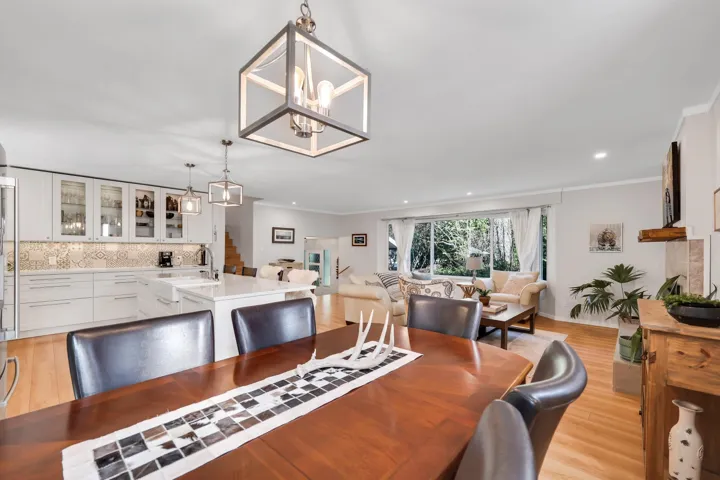 Dining area with crown molding, light wood finished floors, and suspended lighting