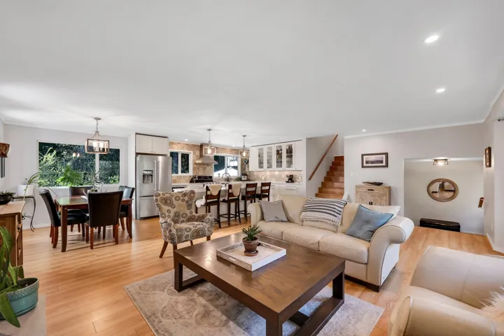 Living room featuring light wood-type flooring, ornamental molding, plenty of natural light, and recessed lighting