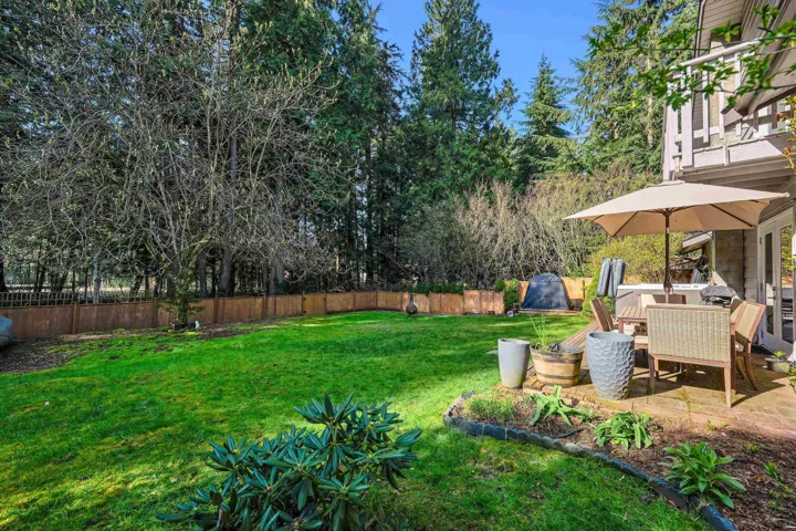 Fenced backyard with outdoor dining area and a patio