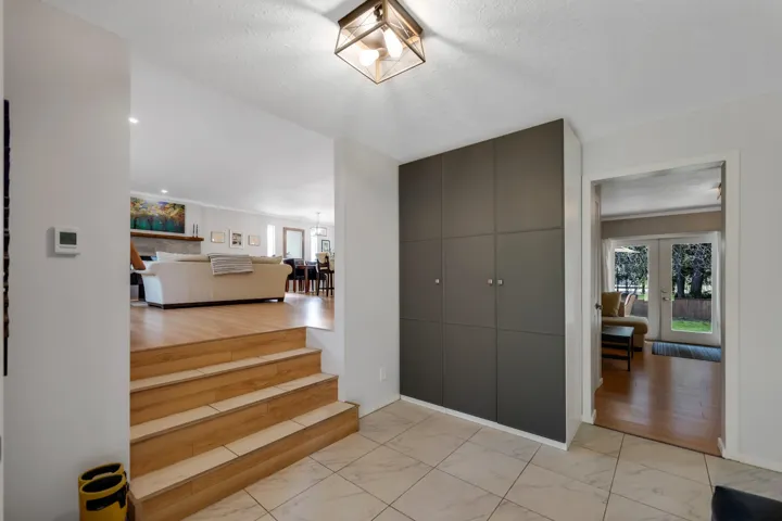 Foyer entrance with a textured ceiling and light marble finish floors