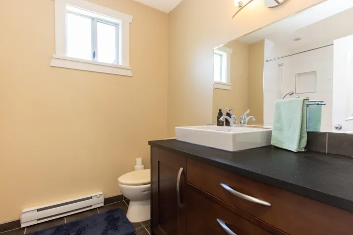 Bathroom featuring a baseboard radiator, vanity, and tile patterned flooring