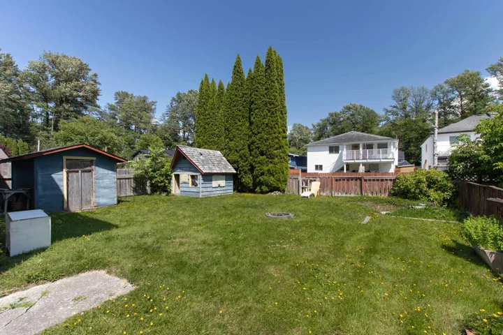 Fenced backyard with a storage shed