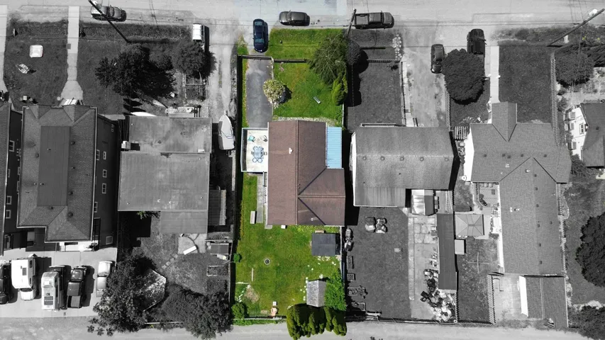 Aerial view of property and surrounding area featuring property parcel outlined
