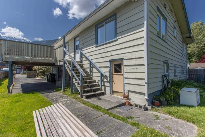 Back of house with a deck, entry steps, and stairway