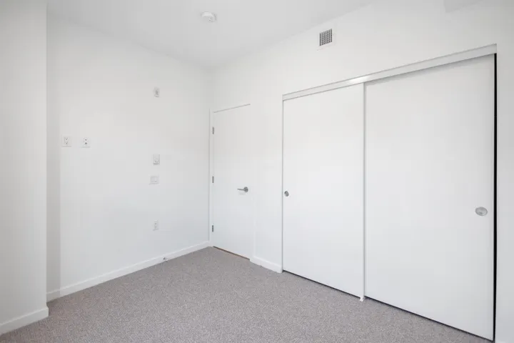 Unfurnished bedroom with carpet floors and a closet