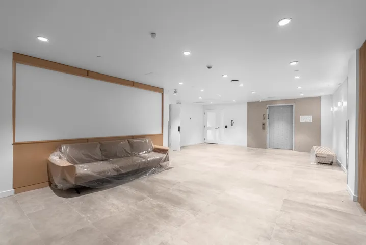 Living room featuring recessed lighting and elevator