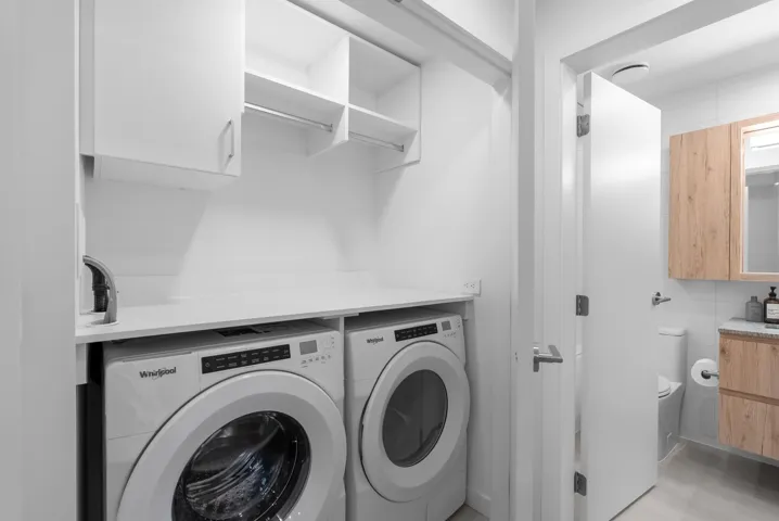 Laundry area with cabinet space and independent washer and dryer