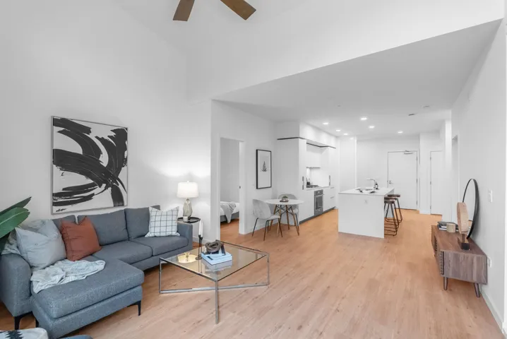 Living area featuring light wood-type flooring, ceiling fan, and recessed lighting