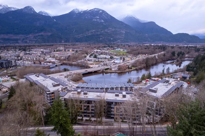 Drone / aerial view of a water and mountain view and a notable bridge