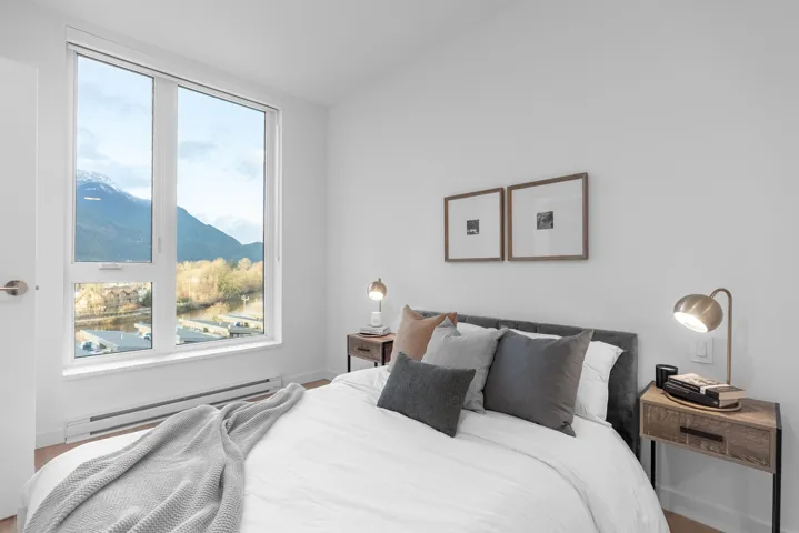 Bedroom featuring baseboard heating and a mountain view