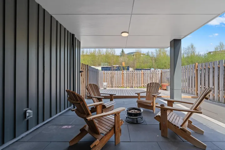 View of patio / terrace with a deck, an outdoor fire pit, and a fenced backyard